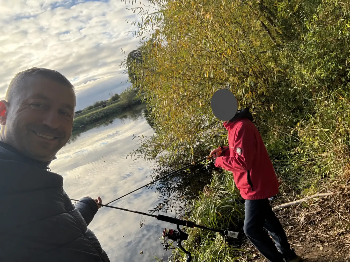 Adrian and his son fishing beside the River Tees after the Darlington move, with the child's face covered